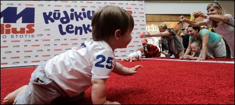 The fastest toddler in Lithuania lured across finish line by jangling keys