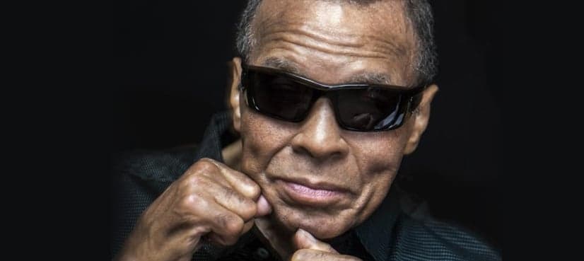 Muhammad Ali poses with his fists, raised one last time