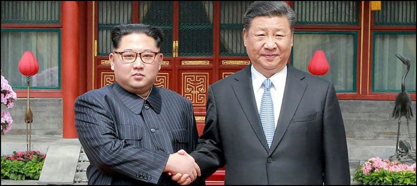 North Korea's Kim shows unity with China's Xi in first foreign trip