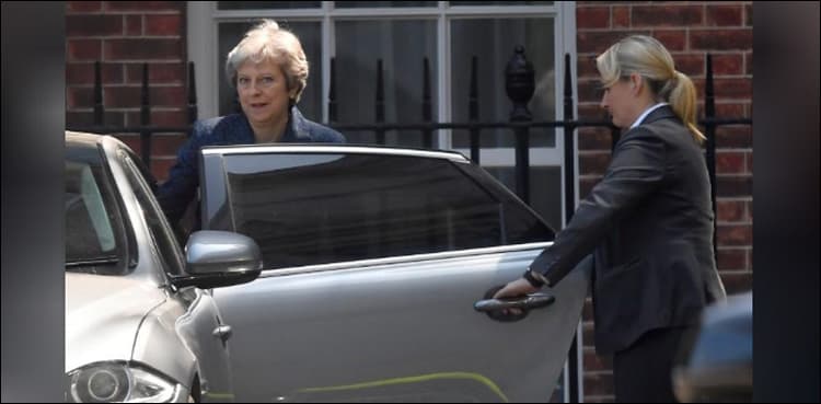 Under pressure to soften Brexit plans, May signals faster pace
