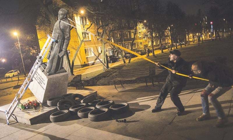 Polish activists pull down priest’s statue in abuse protest