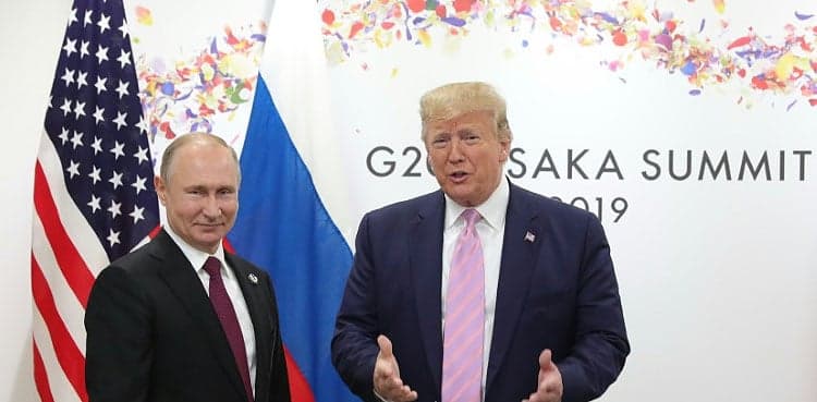With a smile, Trump tells Putin 'don't meddle in the election'