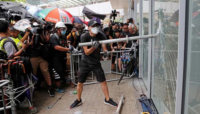 Hong Kong protesters storm legislature as thousands rally to mark handover to China