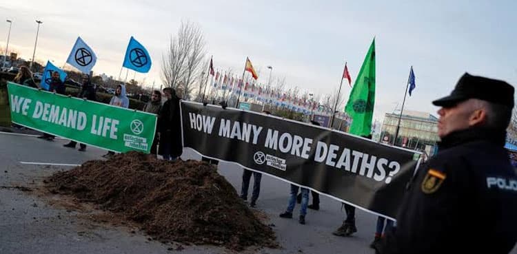 Frustrated with climate talks, activists dump manure outside Madrid summit