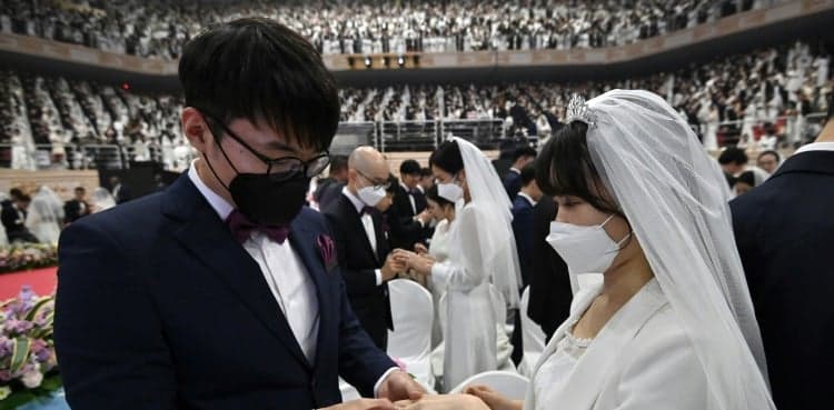 Mass 'face-mask' wedding defies coronavirus fears