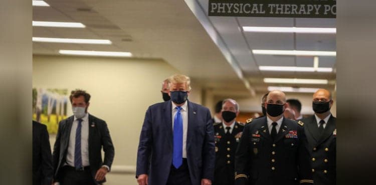 In first, Trump dons masks in visit to a military medical facility
