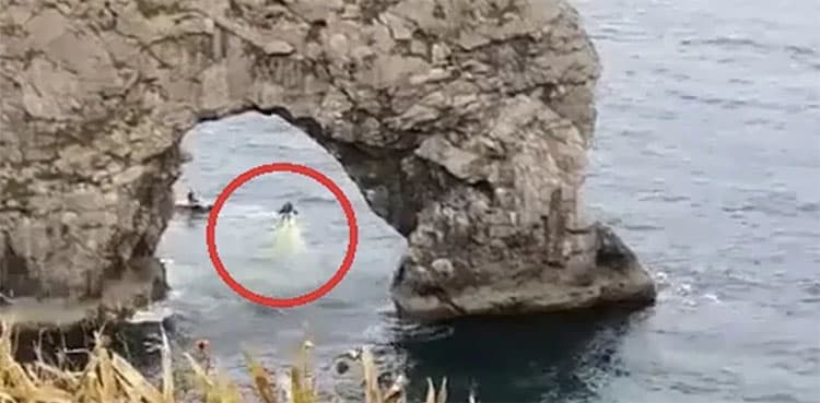 WATCH: Man uses jetpack to fly through Durdle Door arch