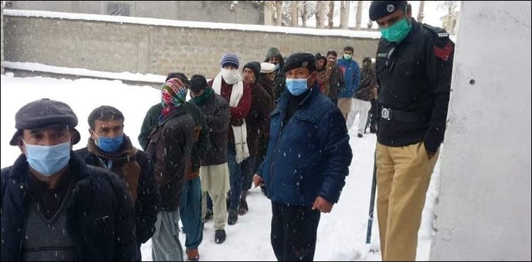 In pictures: GB voters brave heavy snowfall to cast votes