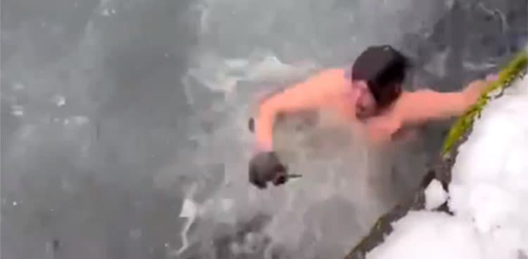 WATCH: Man jumps into icy water to rescue his iPhone