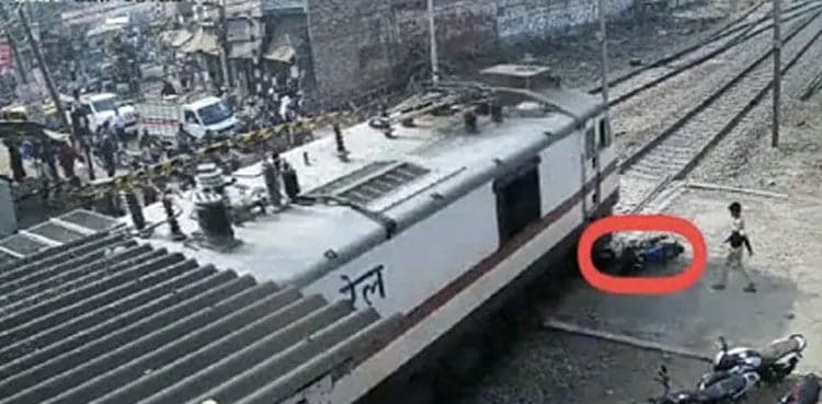 Video: Man narrowly escapes being hit by train, bike crushed