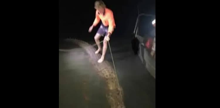 Man rides a giant crocodile like a surfboard, photo goes viral