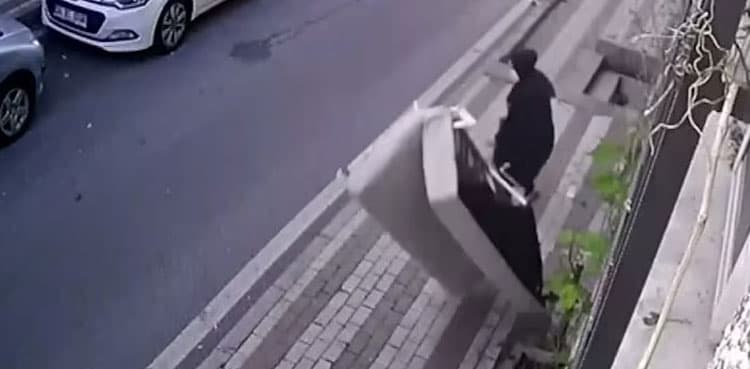 VIDEO: Man throws old sofa out of window and almost kills woman walking below