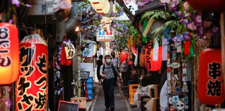 Japan warns of COVID surge, Tokyo raises alert level