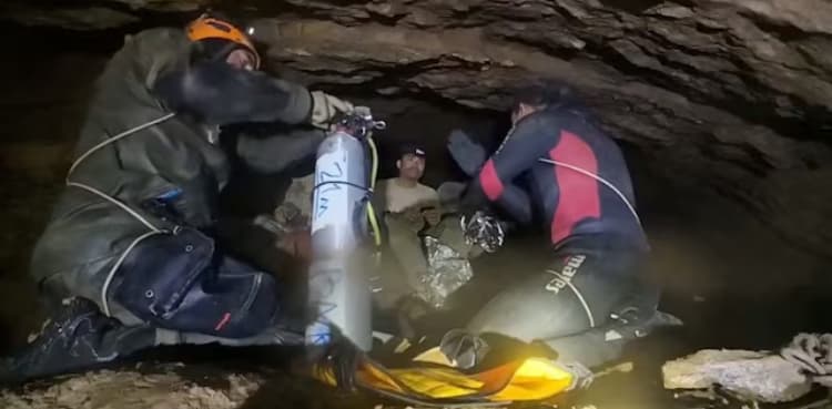 Rescuers pull four from flooded cave in Laos, two still missing