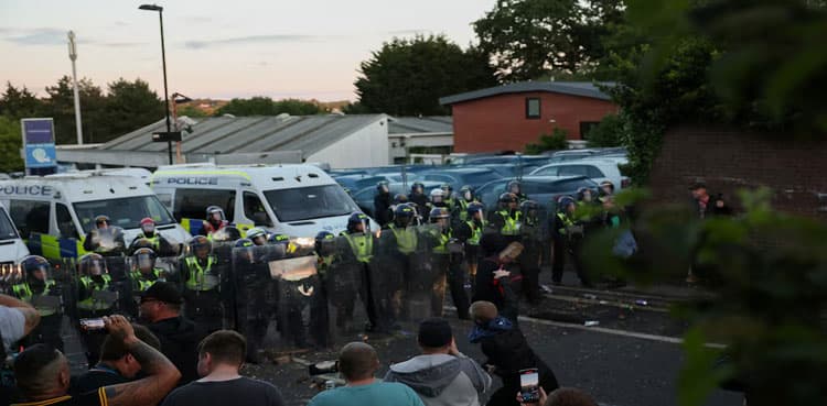 British PM urges calm after protests over handcuffed student's death