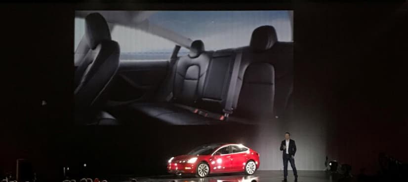 Tesla's Musk hands over first Model 3 electric cars to early buyers