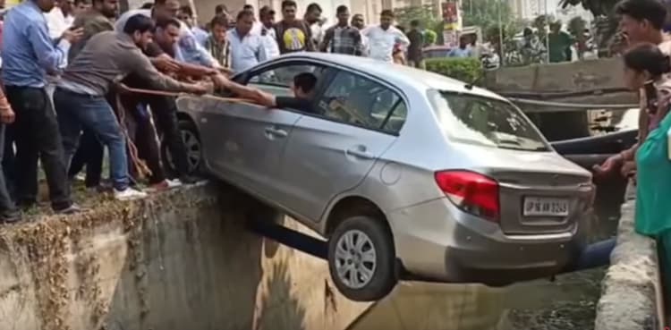 WATCH: Man rescued from car hanging over sewerage line