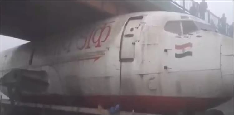 WATCH: Plane gets stuck under highway bridge