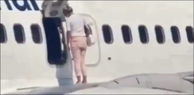 WATCH: Woman walks onto airplane's wing, video goes viral