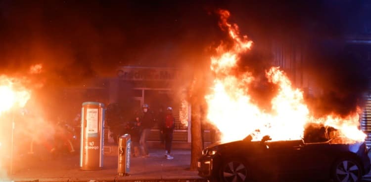 Dozens of protesters in Paris torch cars in riots against Macron's policies