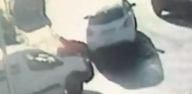 Delivery driver clings on to van's bonnet to stop it being stolen