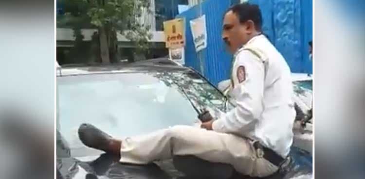 Traffic police officer gets dragged on car, video goes viral
