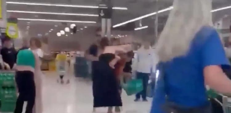 Woman hands over her infant to join supermarket flight