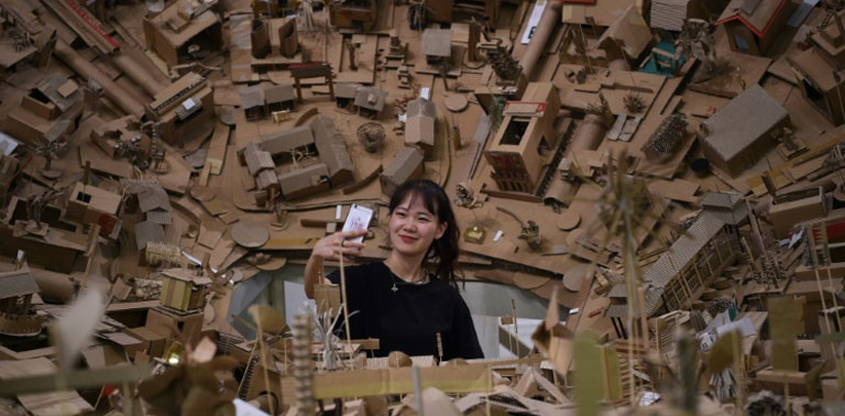 Intricate cardboard city rises!