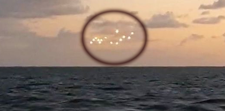 Fleet of glowing 'UFOs' filmed floating in middle of ocean