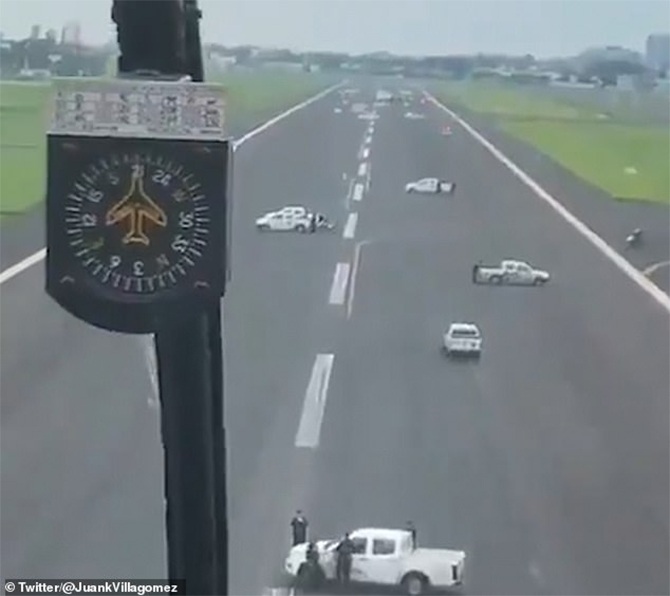 Police park vehicles on runway coronavirus