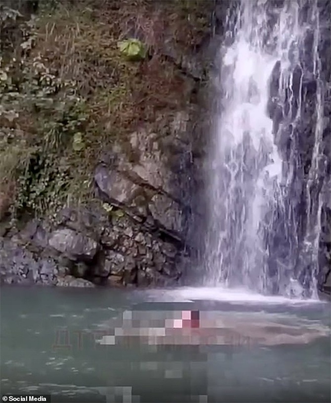 tourist head on rocks diving waterfall video