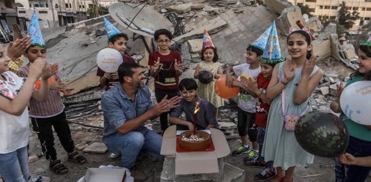 Gazan family celebrates birthday over rubble of building Israel obliterated