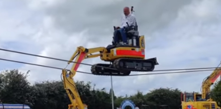 Balancing stunt, digger across tightropes, theme park