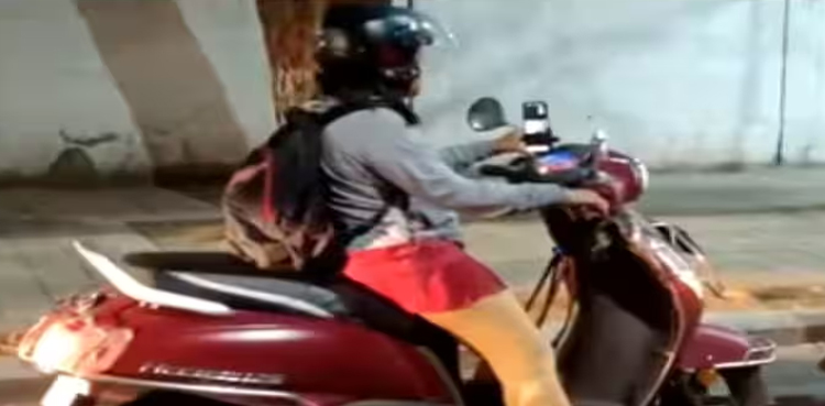 woman attends virtual meeting in traffic, Bengaluru Working woman attends virtual meeting